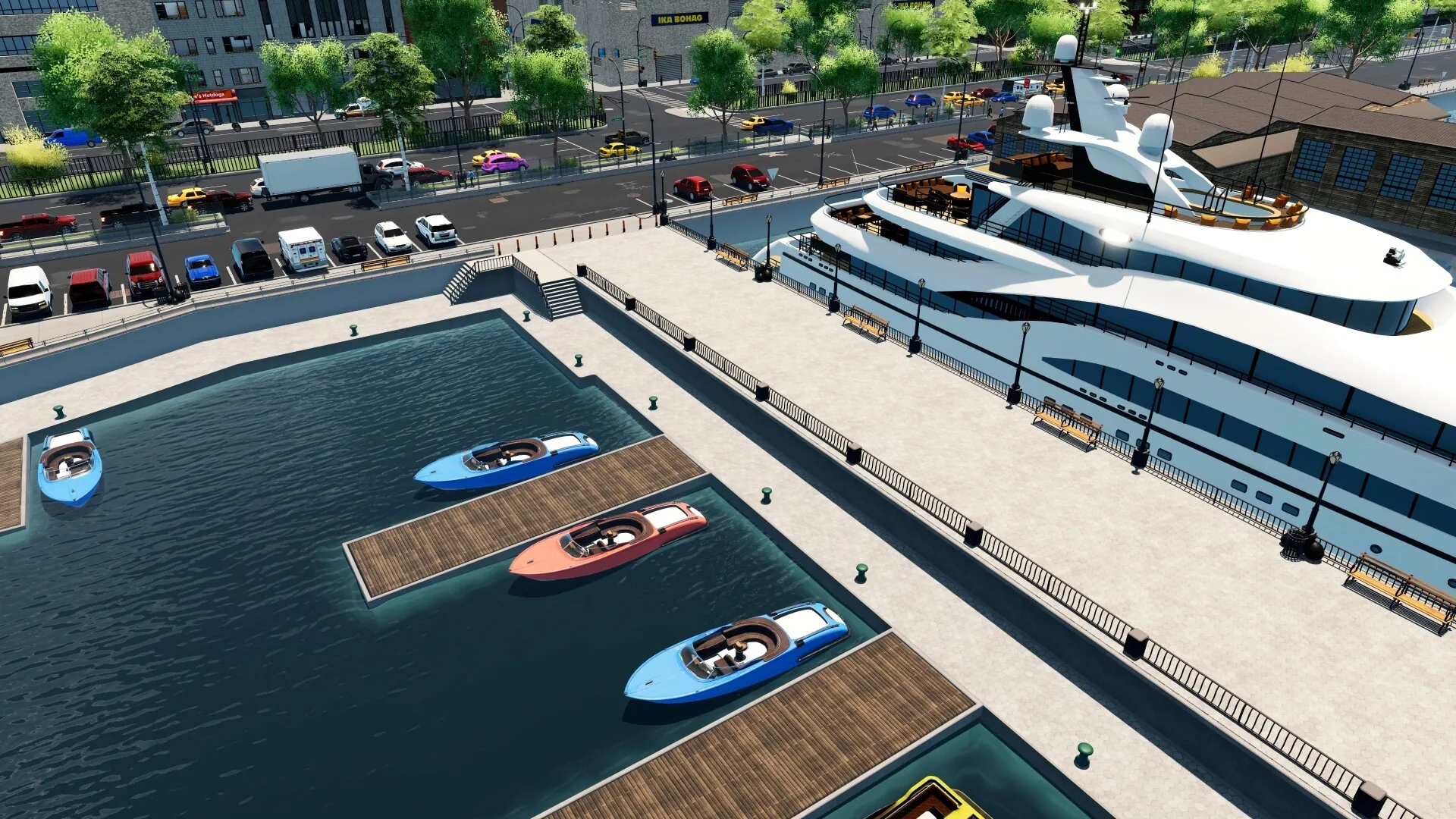 Sunny marina with a white yacht, speedboats at wooden docks and a waterfront street.