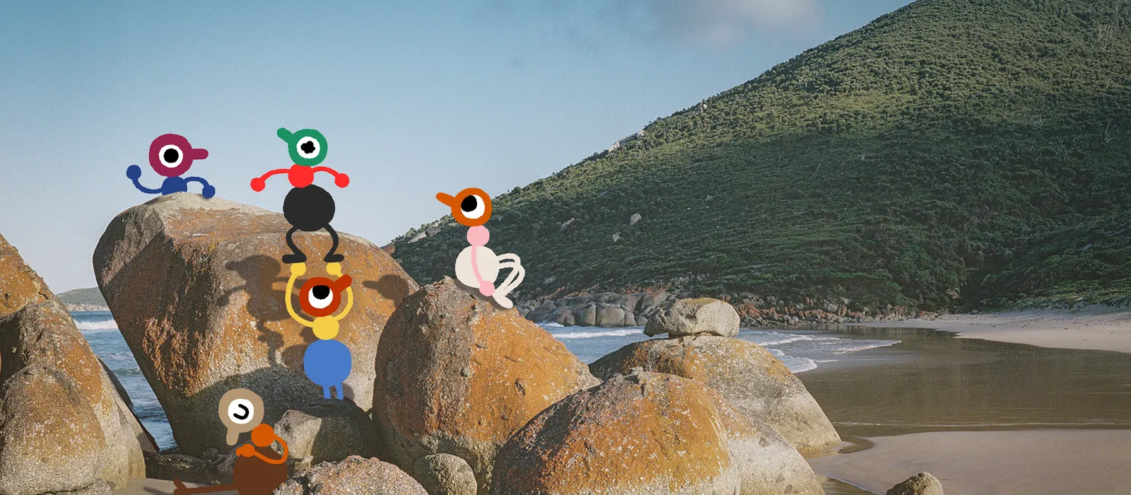 Big Walk key art: a group of one-eyed characters standing on granite boulders on an Australian beach