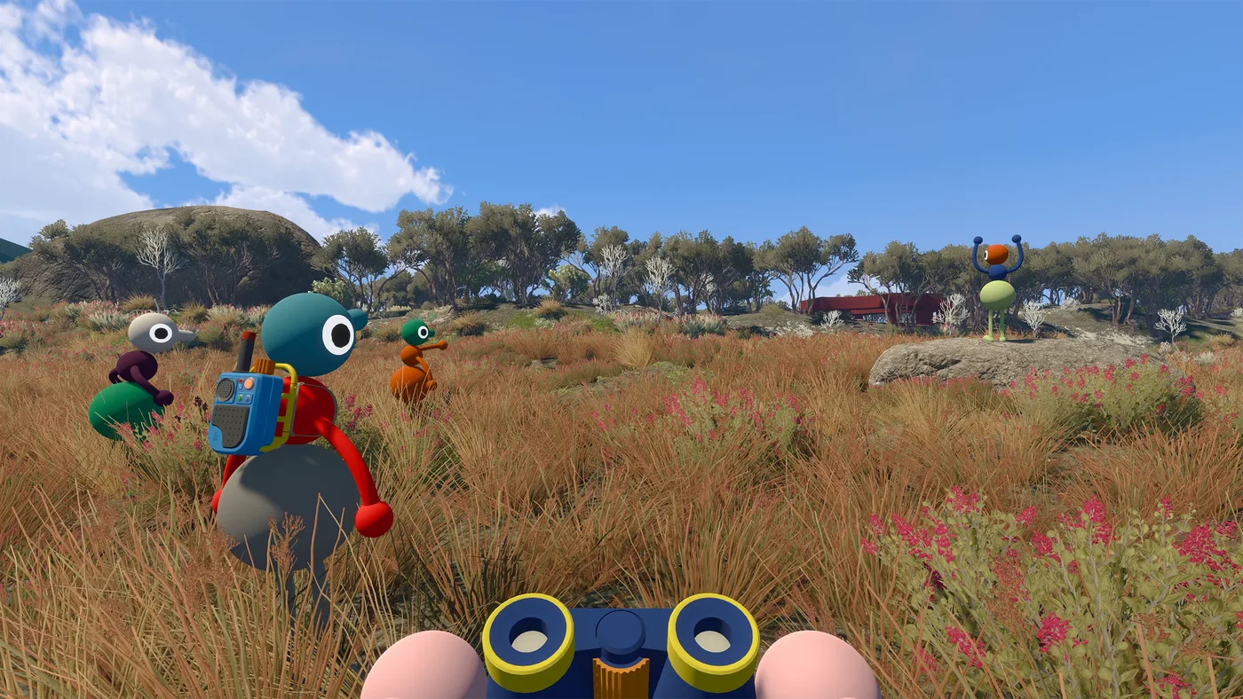First-person view through a pair of blue and yellow binoculars, framing dry grassland. Two other characters stand in the grass ahead, one wearing a backpack (May 2025 build)