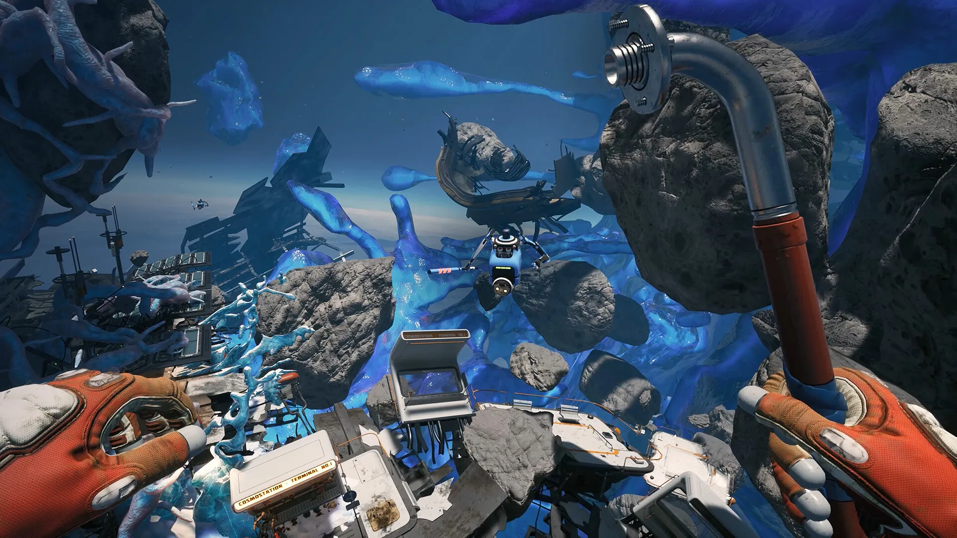 First-person EVA among blue organic masses, rocks, a Cosmostation Terminal and a pipe tool, with another suited figure ahead.