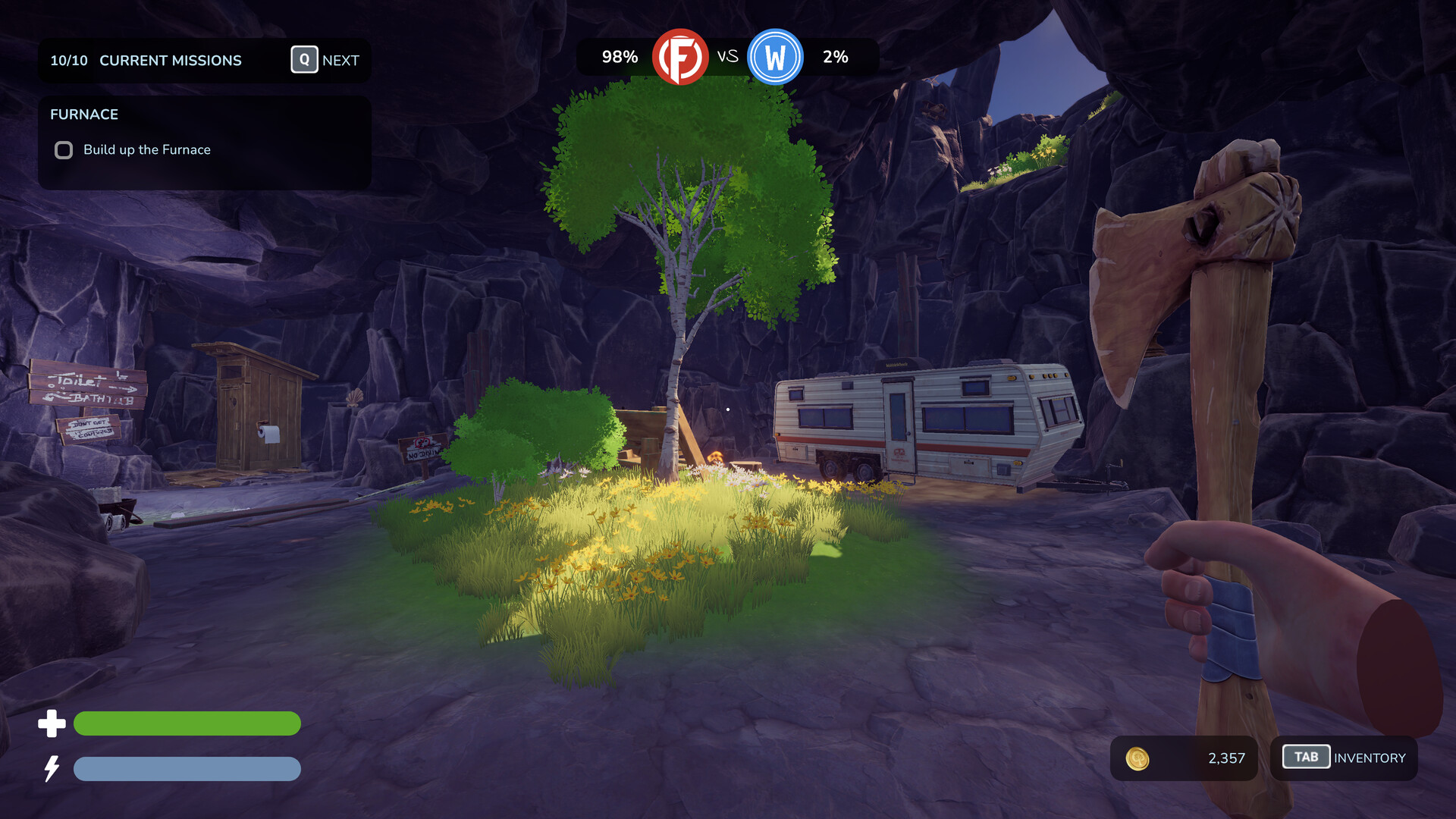 A dark rocky campsite with trees and a parked trailer.