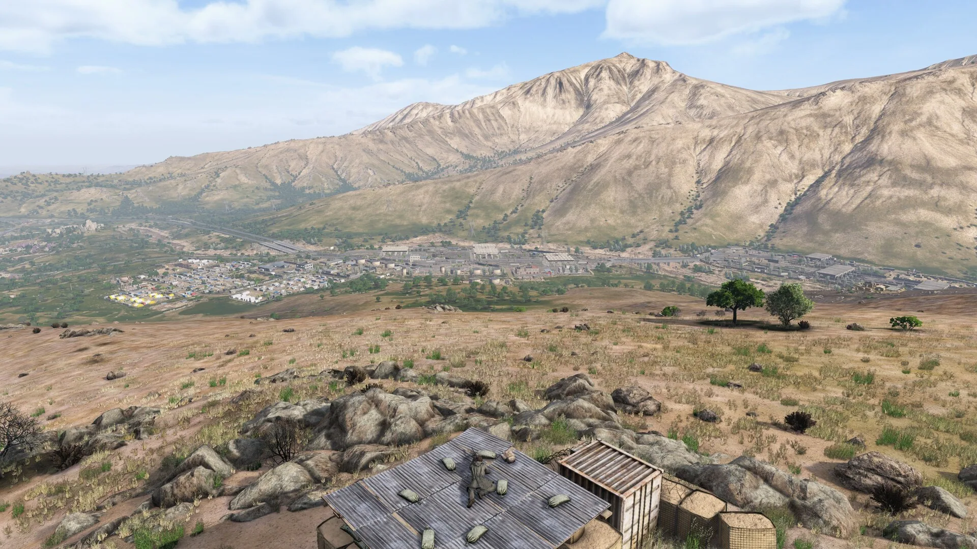 A dry valley with a ridge and a small camp