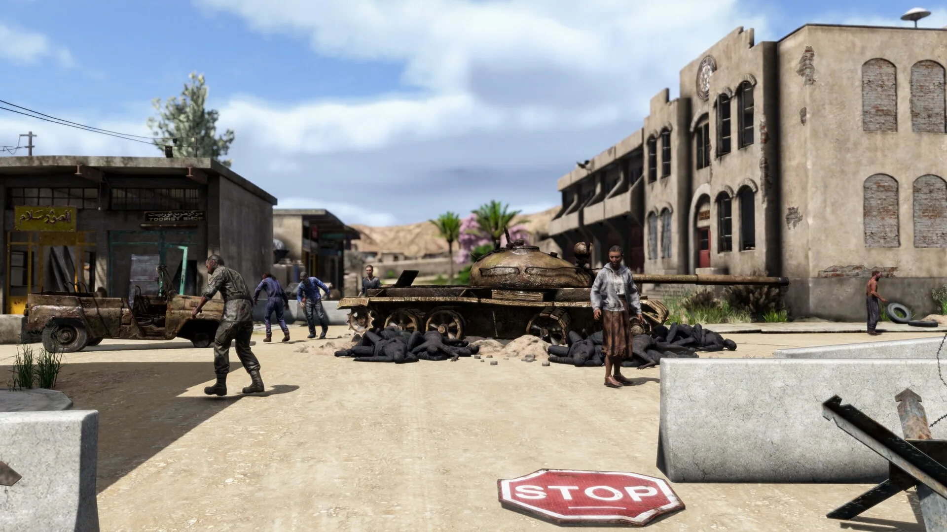A ruined street with a tank, a jeep, and a stop sign
