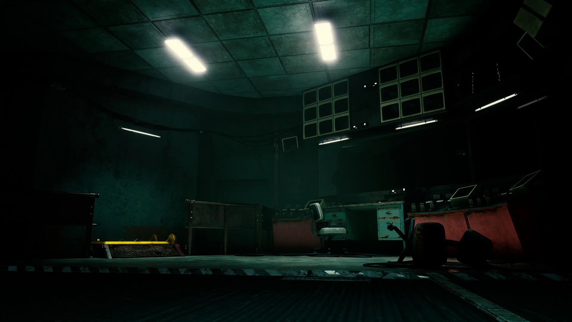 A teal control room lined with lockers
