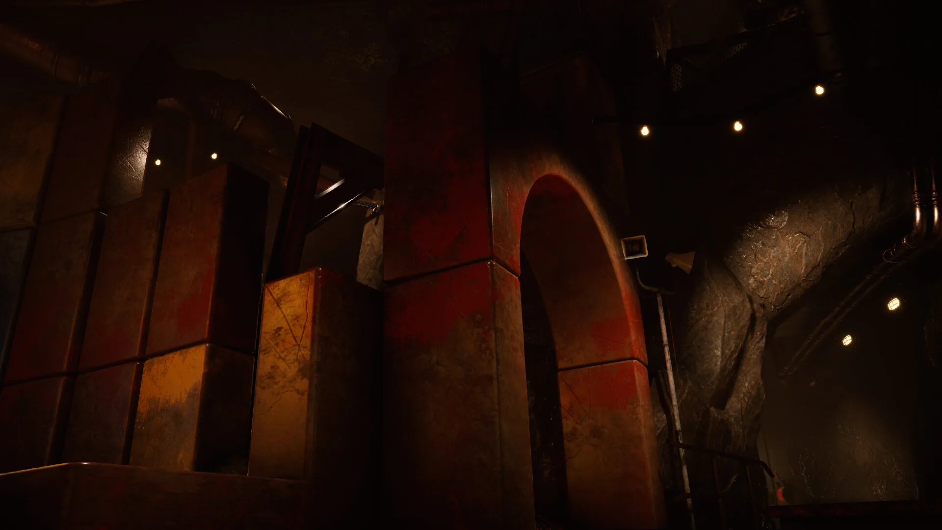 Red-stained blocks under a factory arch