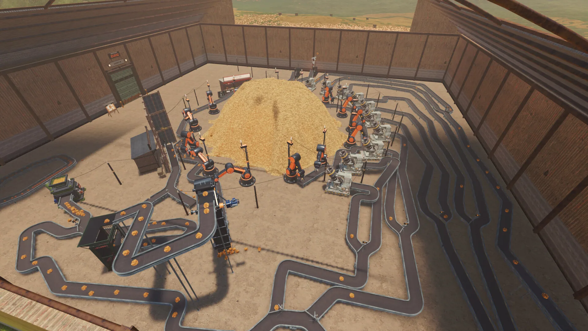 Overhead belts, orange machines, and a central hay mound.