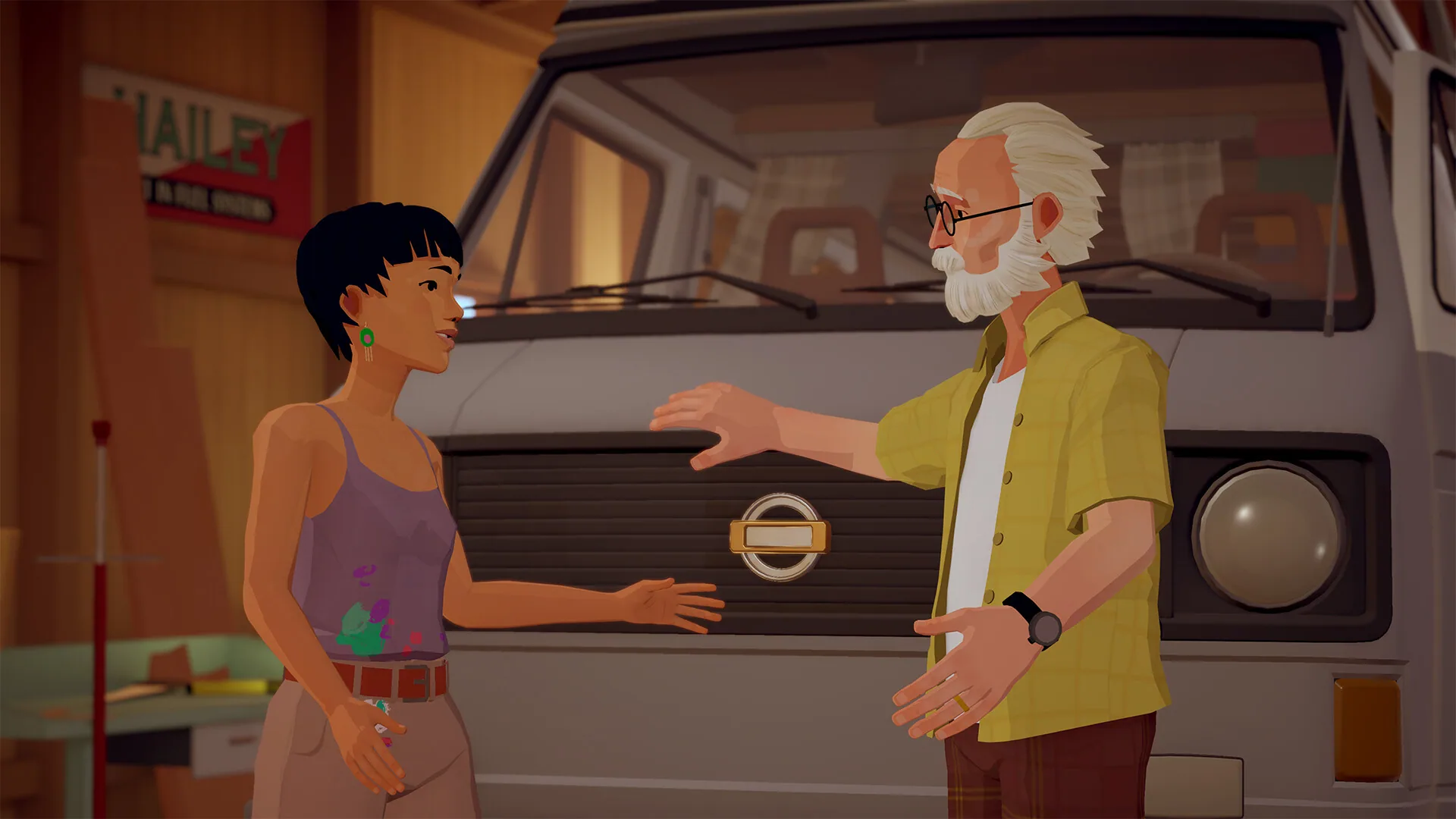 Alfred and Audrey talk beside the van in a wooden garage.