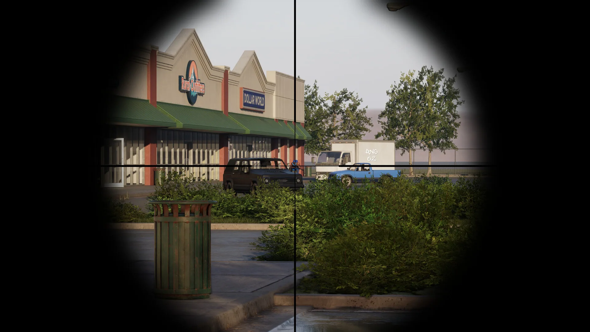 Scoped view of a storefront, trucks, and a blue pickup