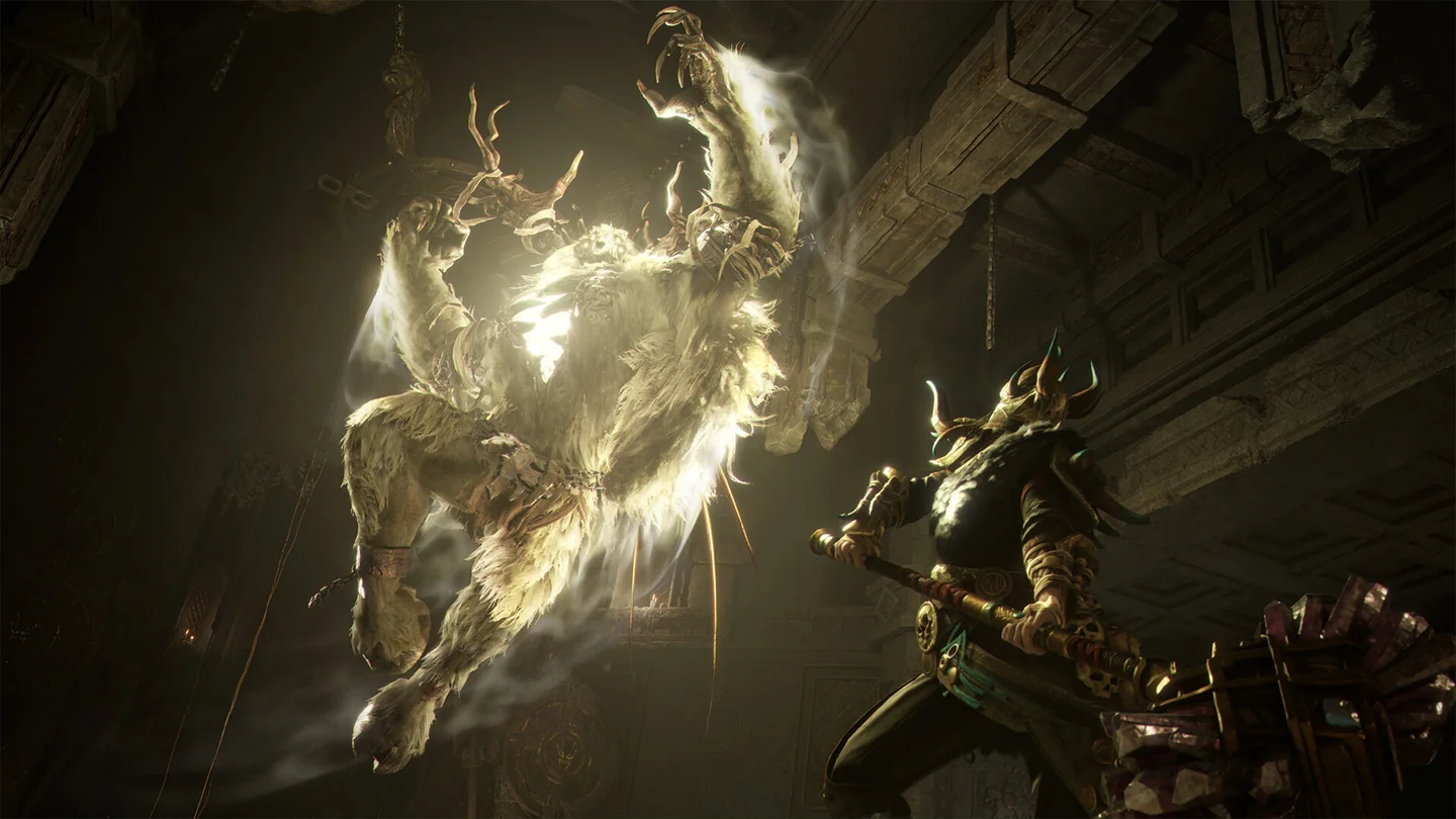 A hammer-wielding hunter fighting a pale beast