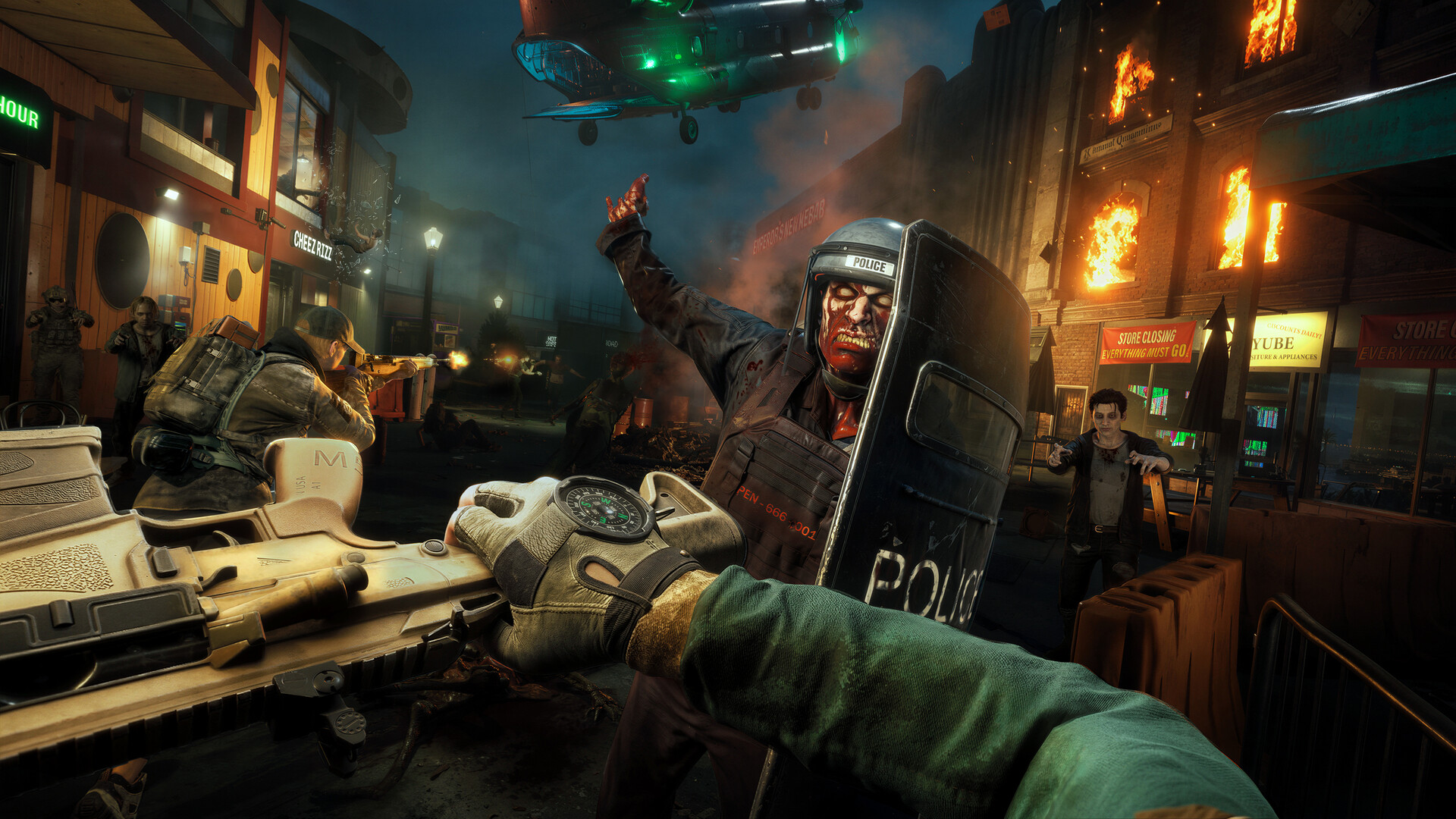 Official Steam first-person screenshot of a street extraction with a helicopter overhead and a riot-shield zombie in a burning town.