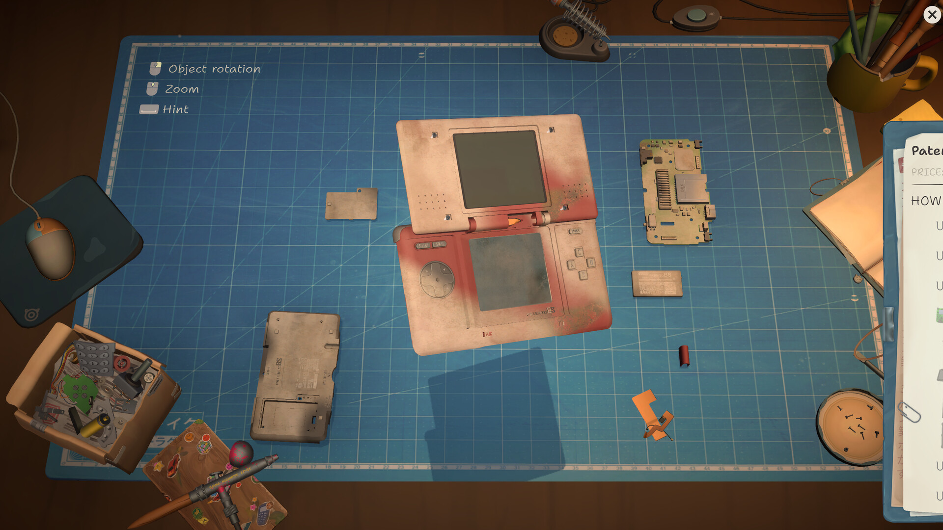Dirty Patento BS handheld opened into casing, board and loose components on the repair mat.
