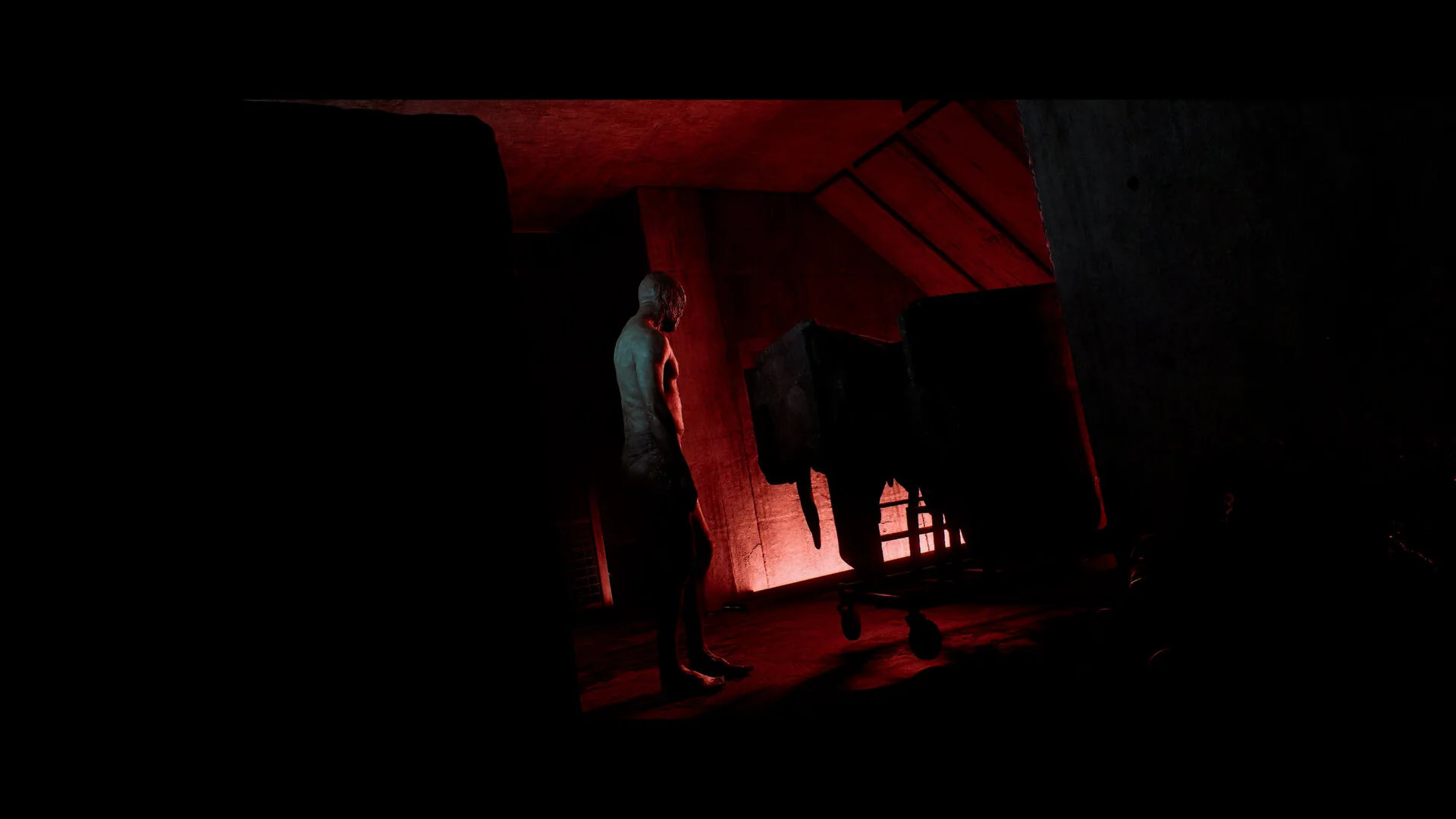 A dim interior corridor with wet walls and a distant doorway.