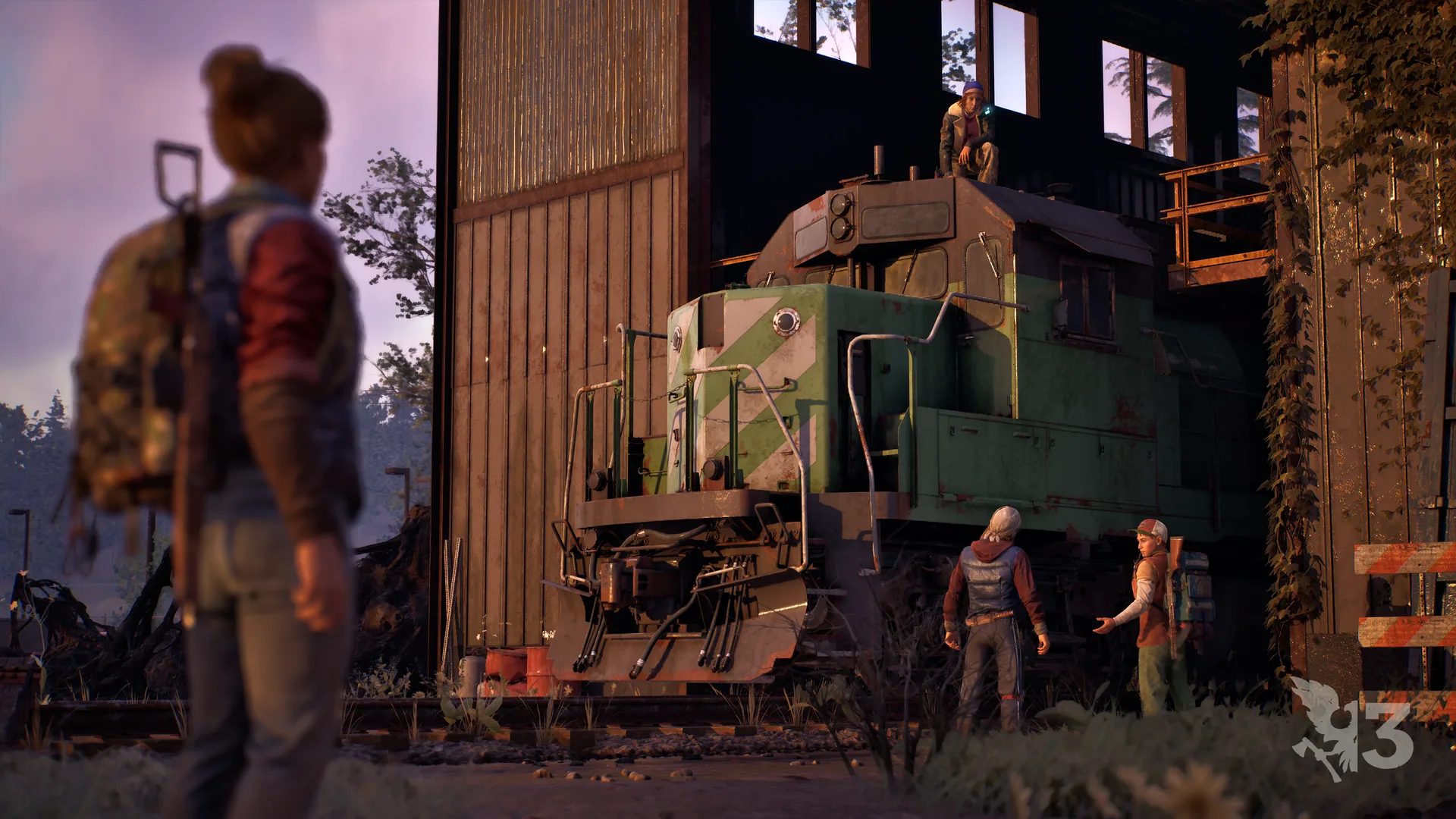 Survivor watching two companions beside a green locomotive inside a wooden building