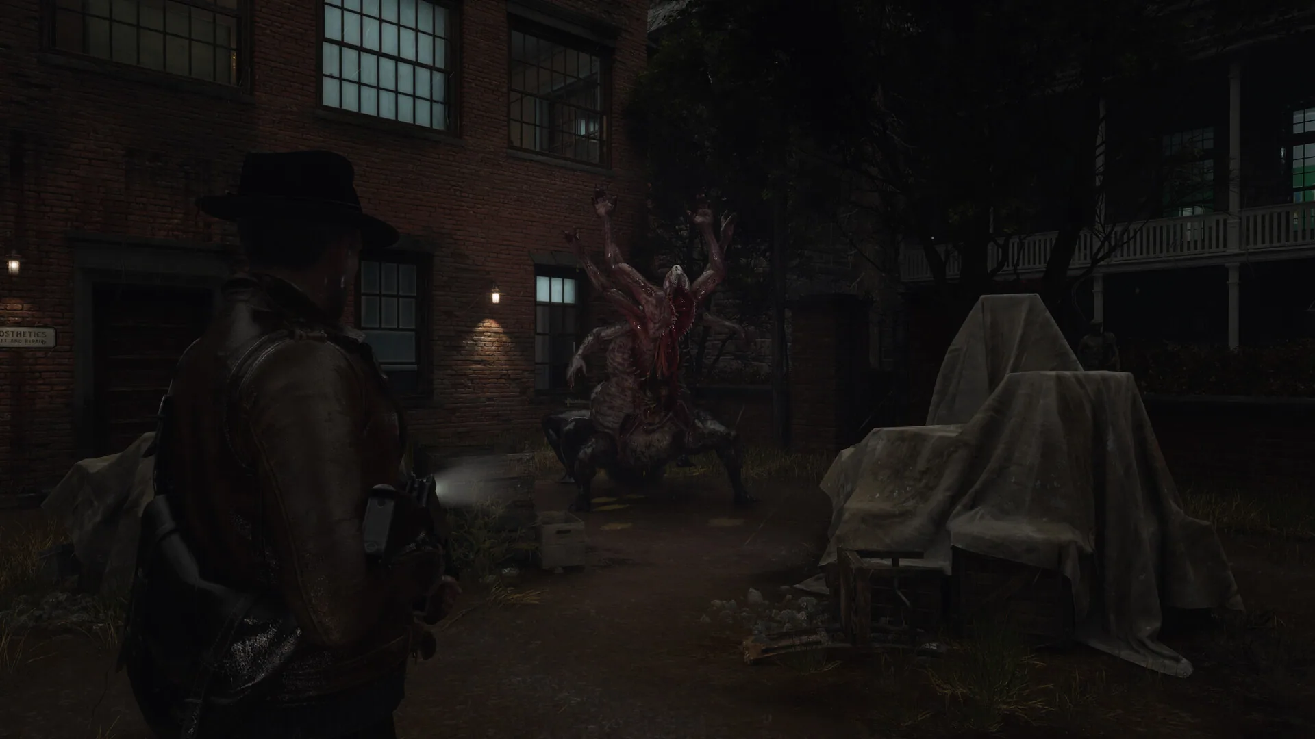 Calvin Rafferty aims a flashlight and gun at a multi-armed fleshy creature in a brick courtyard at night