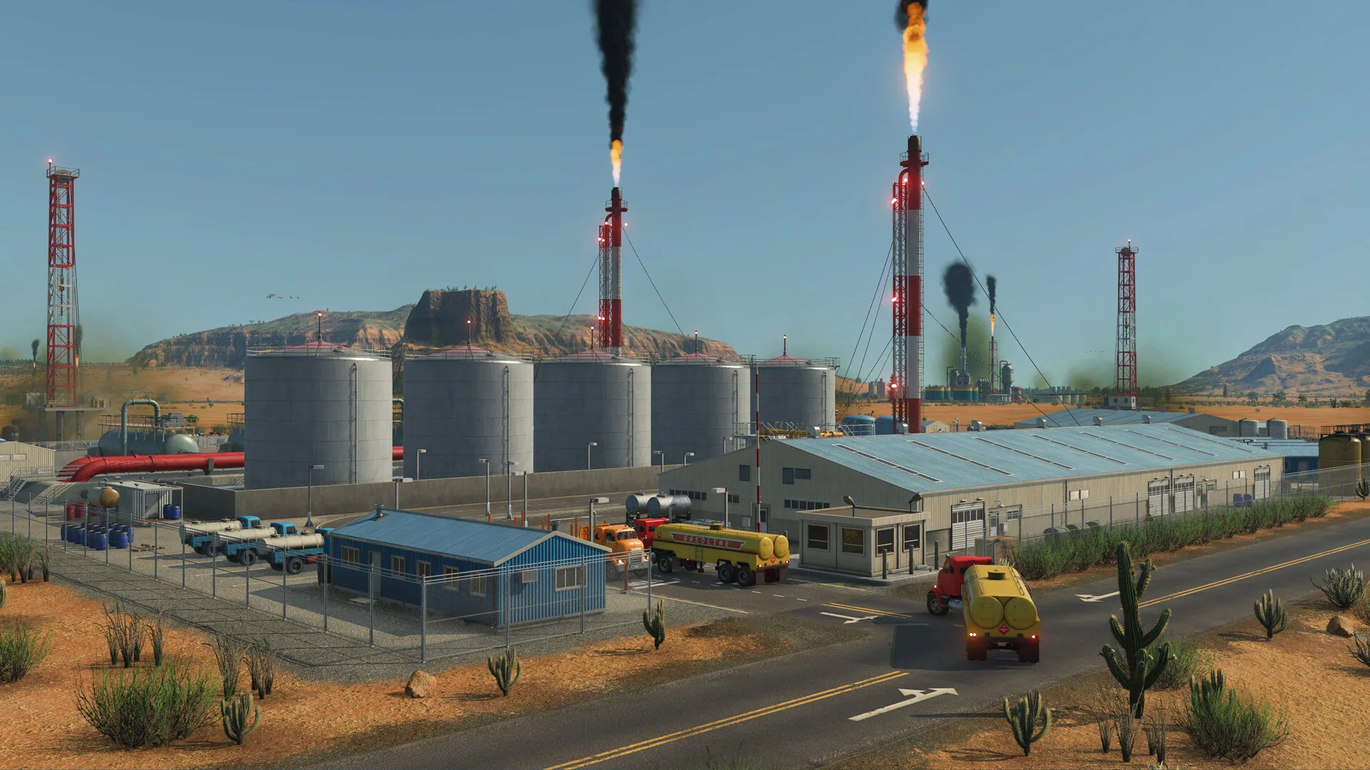 Desert oil terminal with silver tanks, flare stacks and tanker trucks