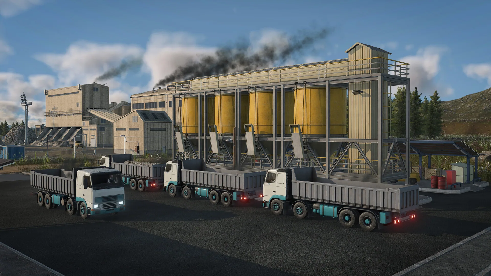 Four dump trucks queued under yellow bulk silos at an industrial plant