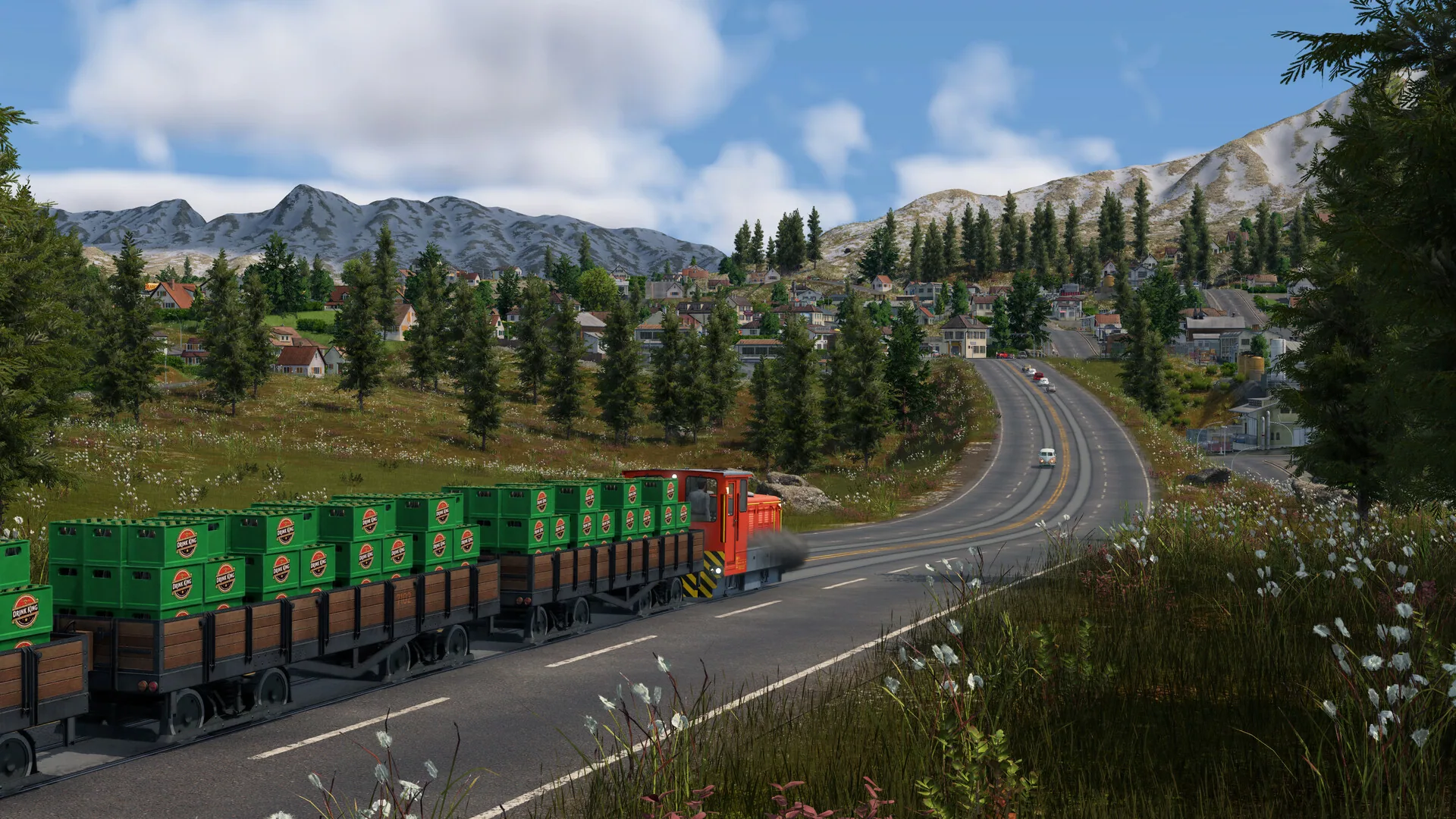 Orange truck hauling green crate trailers on a mountain highway